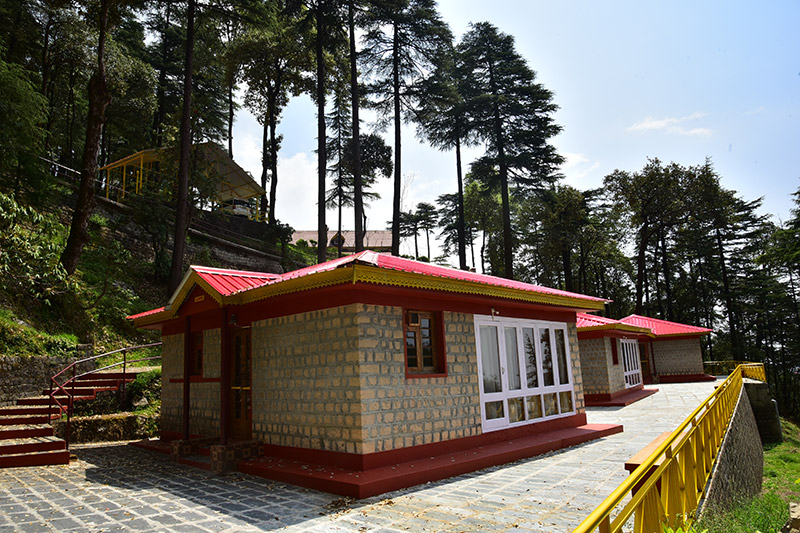 Exterior of a small cottage with a glazed verandah